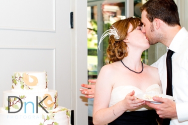 Bride and Groom Kiss by Cake