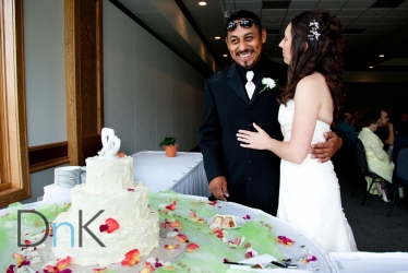 bride and groom by cake