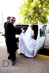 bride and groom getting in limo