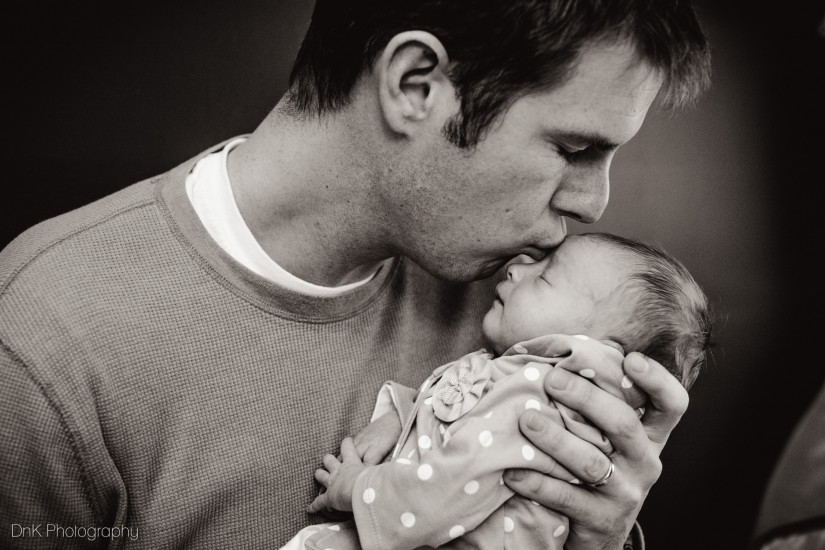 father kissing his baby girl