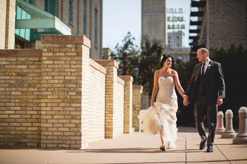 bride and groom walking in downtown Minneapolis