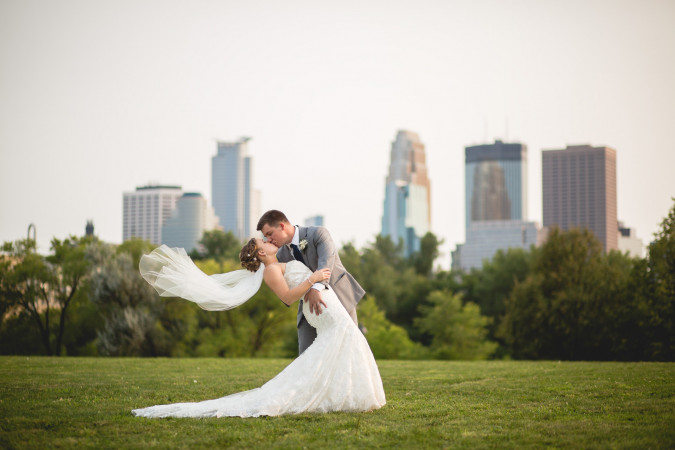 Bride and Groom dipping with Minneapolis Skyline